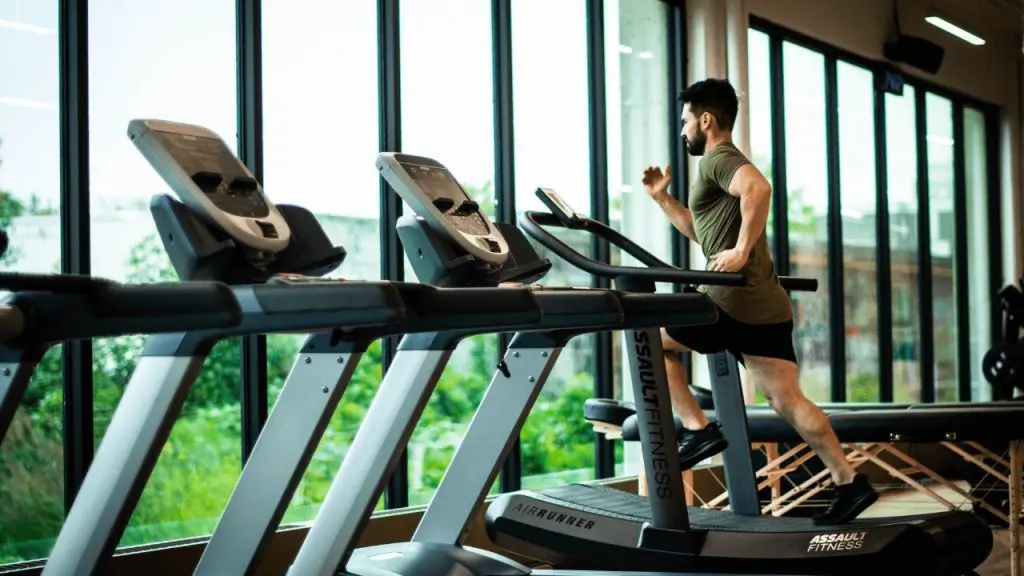 a man running on a treadmill in a gym