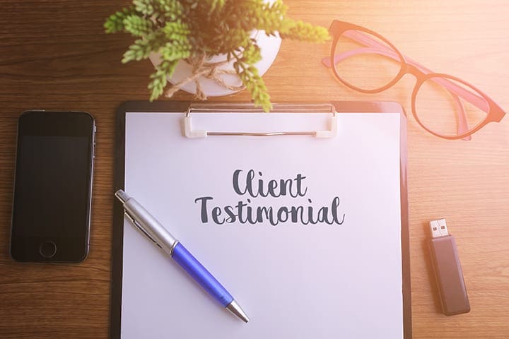 a pad of paper with "client testimonial" on it