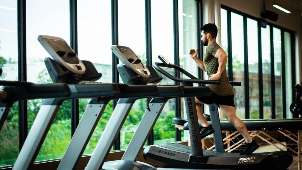 a man running on a treadmill in a gym