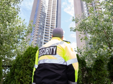 Security guard in uniform patrolling a residential area.