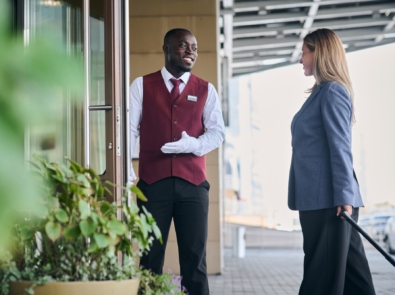 Doorman opening door for guest