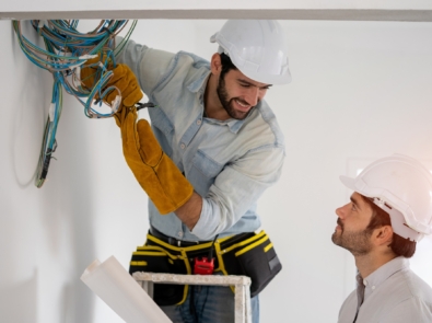 Electrician working working on building site, Maintenance technicians install wiring in the home.
