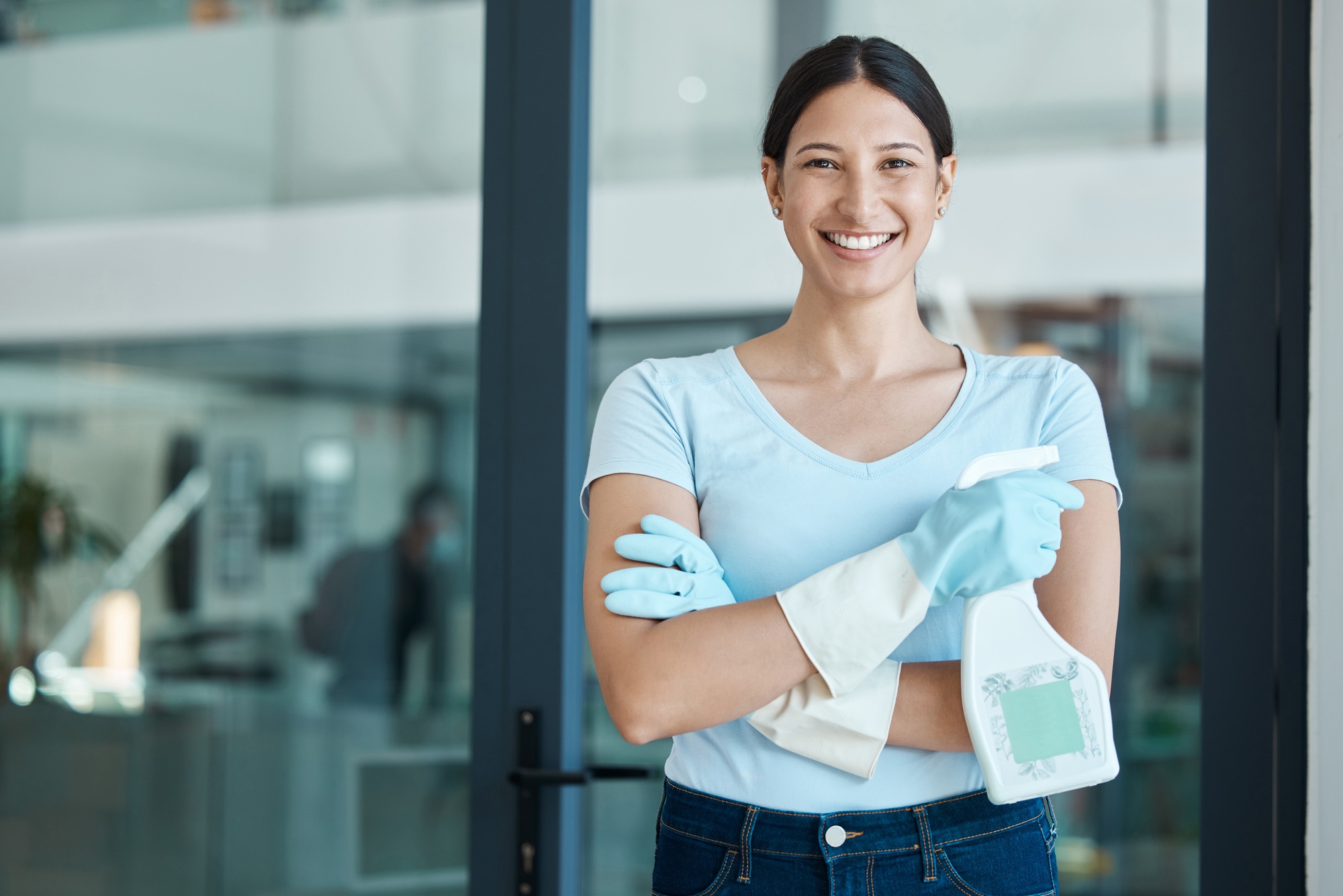 Cleaning service, portrait and cleaner in an office with spray bottle of disinfectant, bleach or de