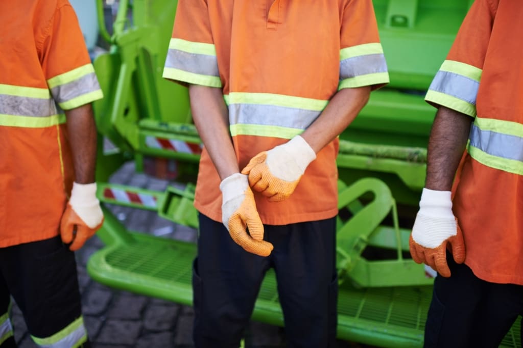 Collecting your trash. Cropped shot of a garbage collection team.