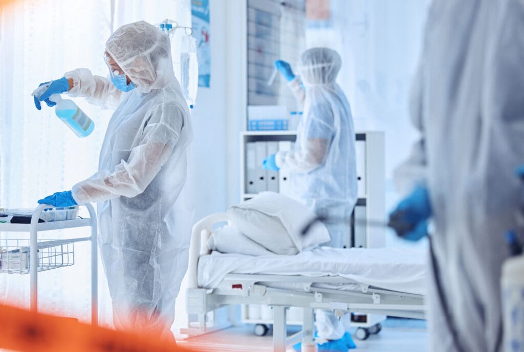 Hospital, contamination and people cleaning with disinfection for biohazard, safety or protocol. Red tape, medical and work with PPE in ward for healthcare compliance, sanitation or infection control