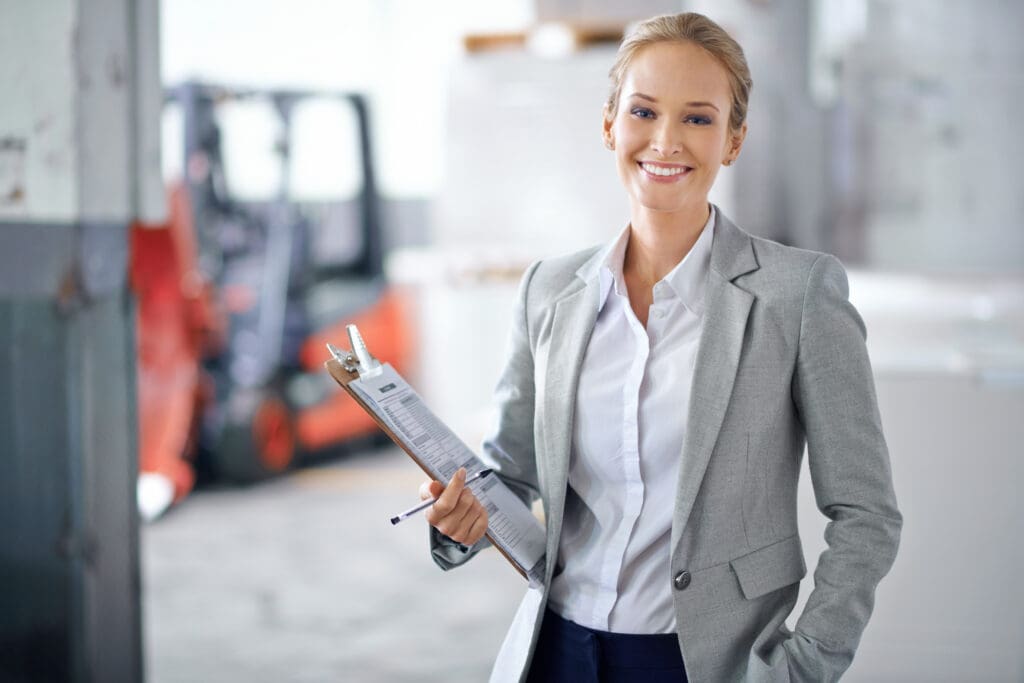 I ensure success every step of the way. A young manager looking confident while on the factory floor.